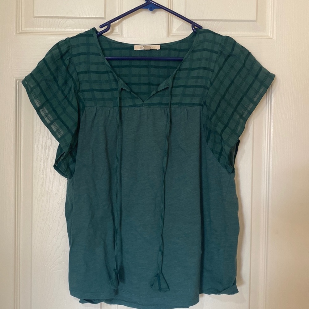Short sleeve green shirt with flutter sleeve and tie front.